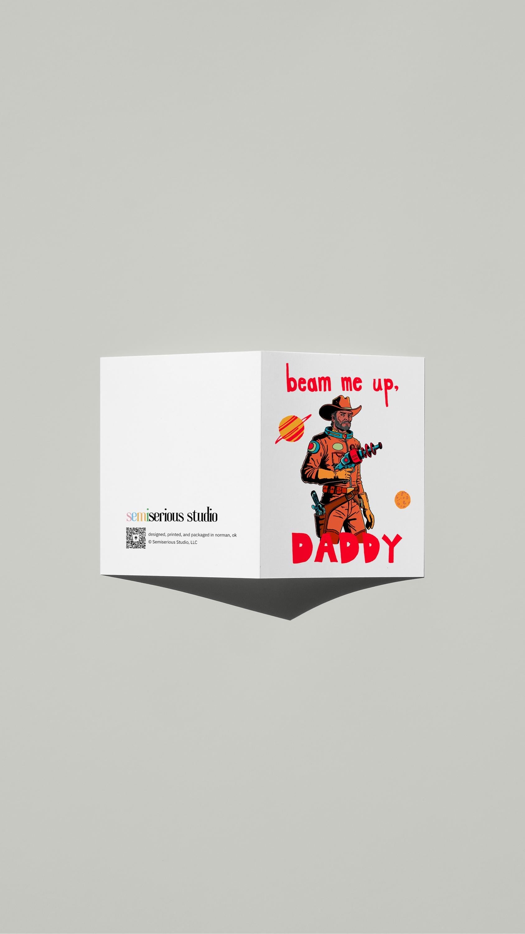 Space Daddy Pride card standing open, showing the front artwork and the Semiserious Studio logo on the back