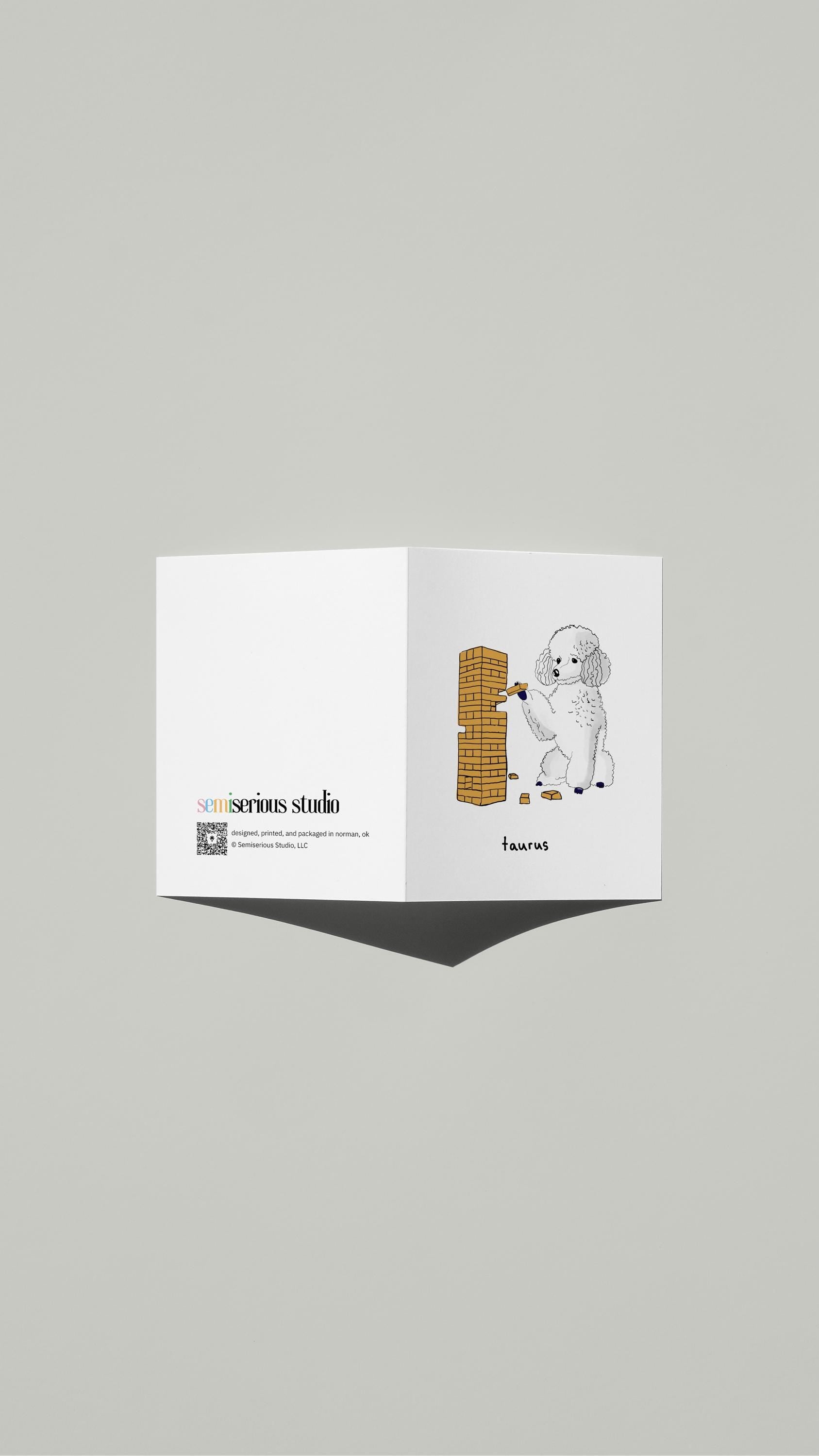 Taurus Poodle Jenga Birthday card standing open, showing the front artwork and the Semiserious Studio logo on the back