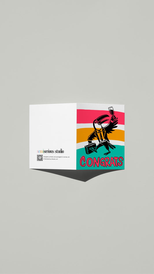 Toucan Congrats card standing open, showing the front artwork and the Semiserious Studio logo on the back