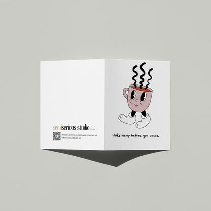 Wake Me Up Before You Cocoa Christmas card standing open, showing the front artwork and the Semiserious Studio logo on the