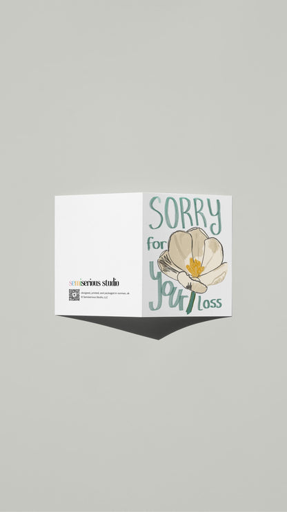 White Flower Sympathy card standing open, showing the front artwork and the Semiserious Studio logo on the back