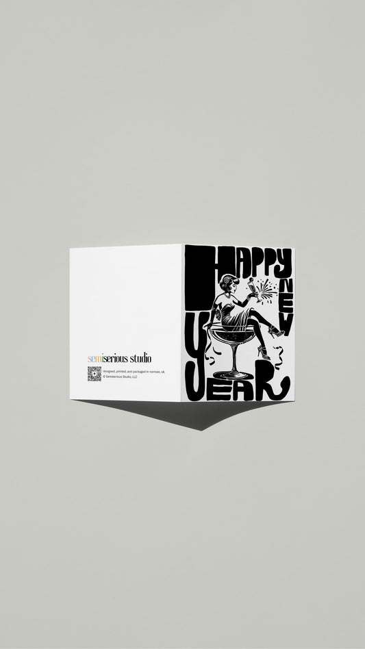 Woman with Champagne New Year card standing open, showing the front artwork and the Semiserious Studio logo on the back