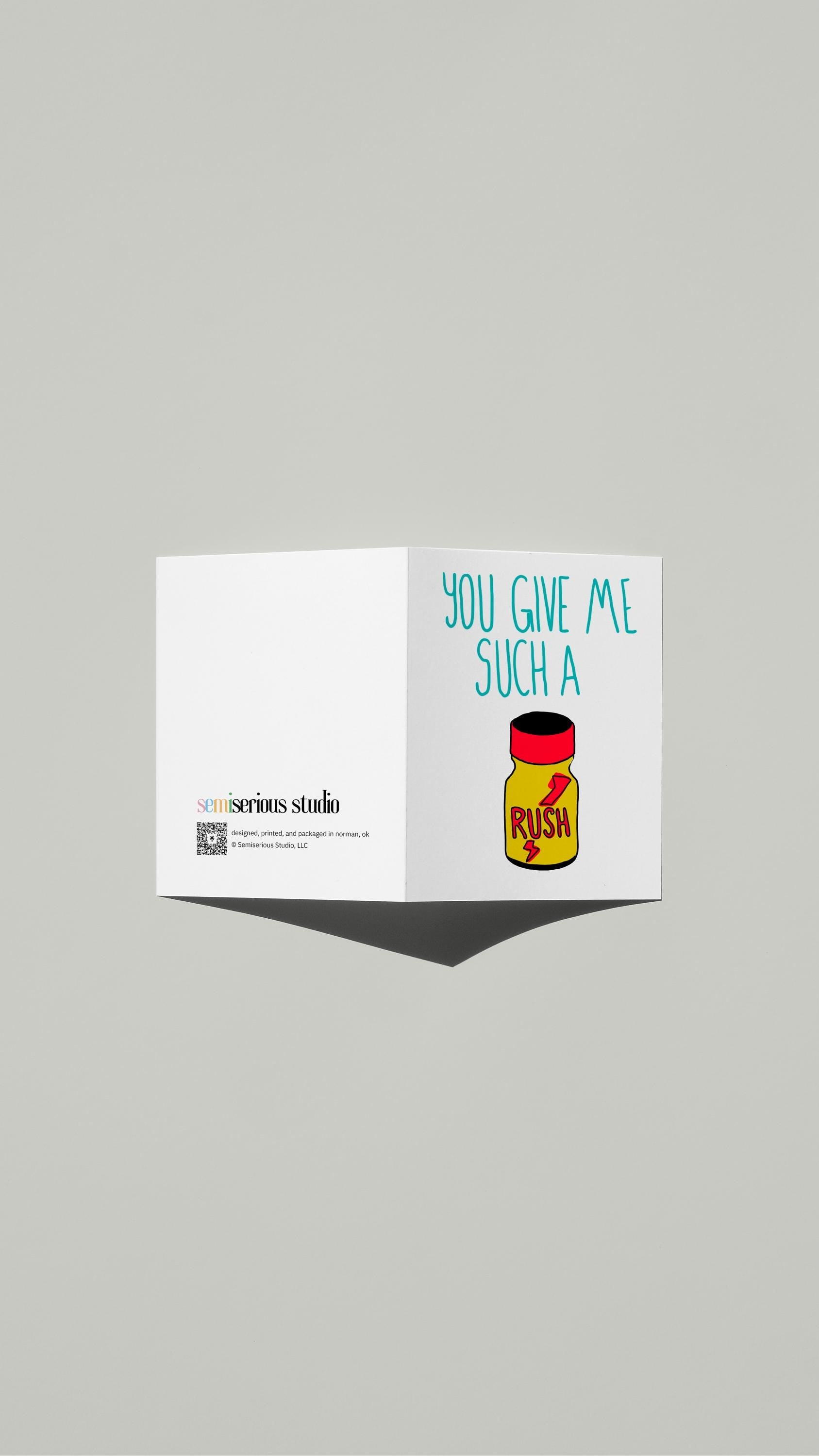 You Give Me Such a Rush Pride card standing open, showing the front artwork and the Semiserious Studio logo on the back