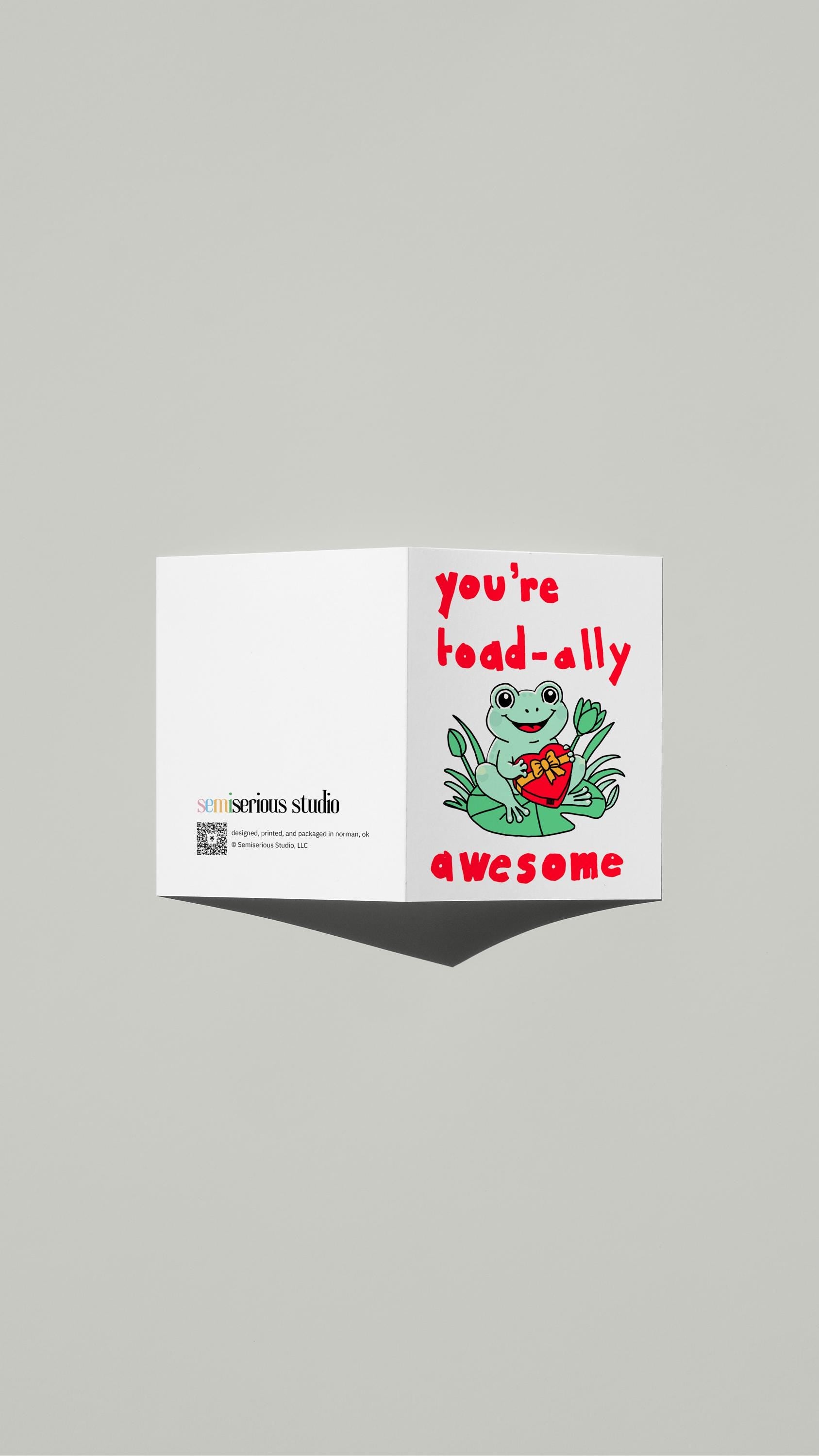You're Toad-ally Awesome Valentine card standing open, showing the front artwork and the Semiserious Studio logo on the back