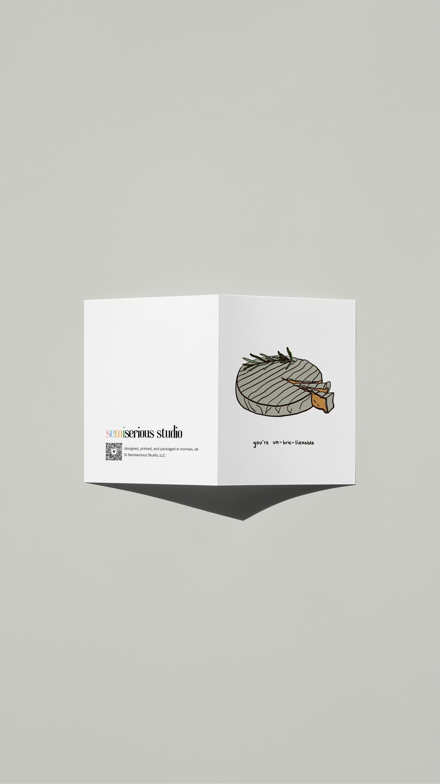 You're Un-Brie-Lievable Valentine card standing open, showing the front artwork and the Semiserious Studio logo on the back