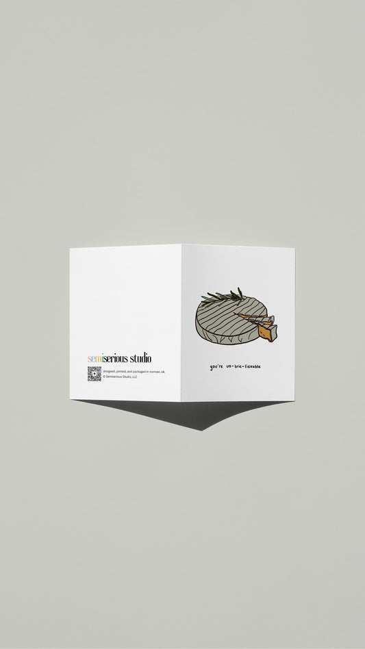 You're Un-Brie-Lievable Valentine card standing open, showing the front artwork and the Semiserious Studio logo on the back
